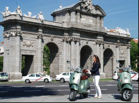 Madrid vespa in front of the Puerta de Alcala